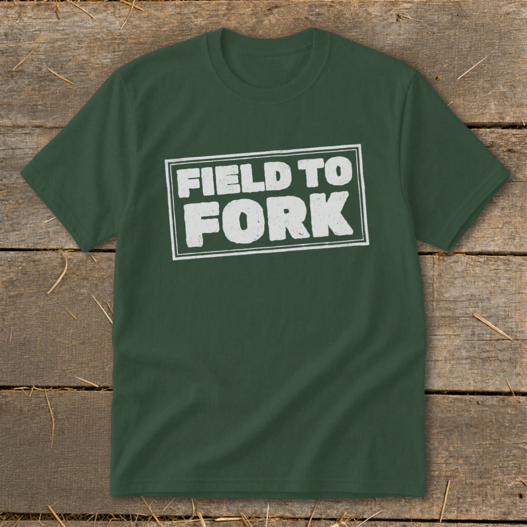 A dark green t-shirt with white distressed text inside a rectangle reading FIELD TO FORK.