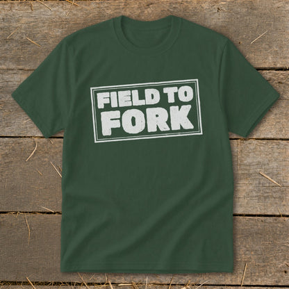 A dark green t-shirt with white distressed text inside a rectangle reading FIELD TO FORK.