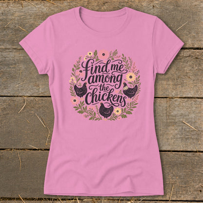 Pink t-shirt with floral wreath and "Find me among the chickens" text.