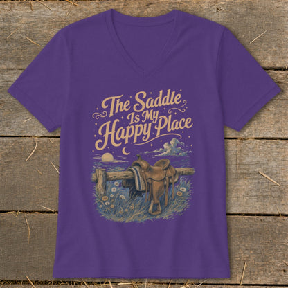 Purple v-neck shirt with "The Saddle Is My Happy Place" and a saddle on a fence.