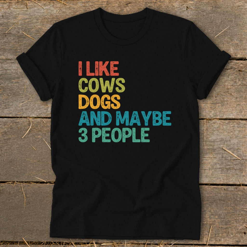 Black t-shirt with text "I LIKE COWS DOGS AND MAYBE 3 PEOPLE".