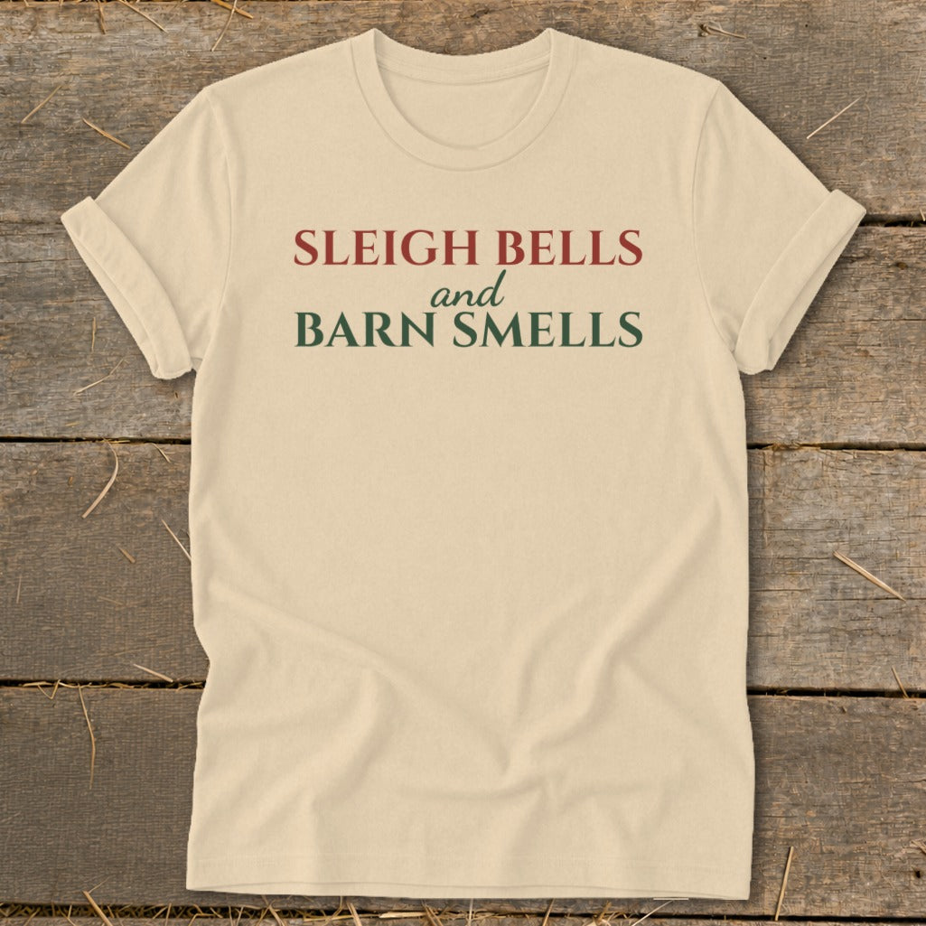 Cream t-shirt with red and green text reading "Sleigh Bells and Barn Smells".