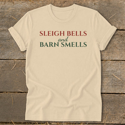Cream t-shirt with red and green text reading "Sleigh Bells and Barn Smells".