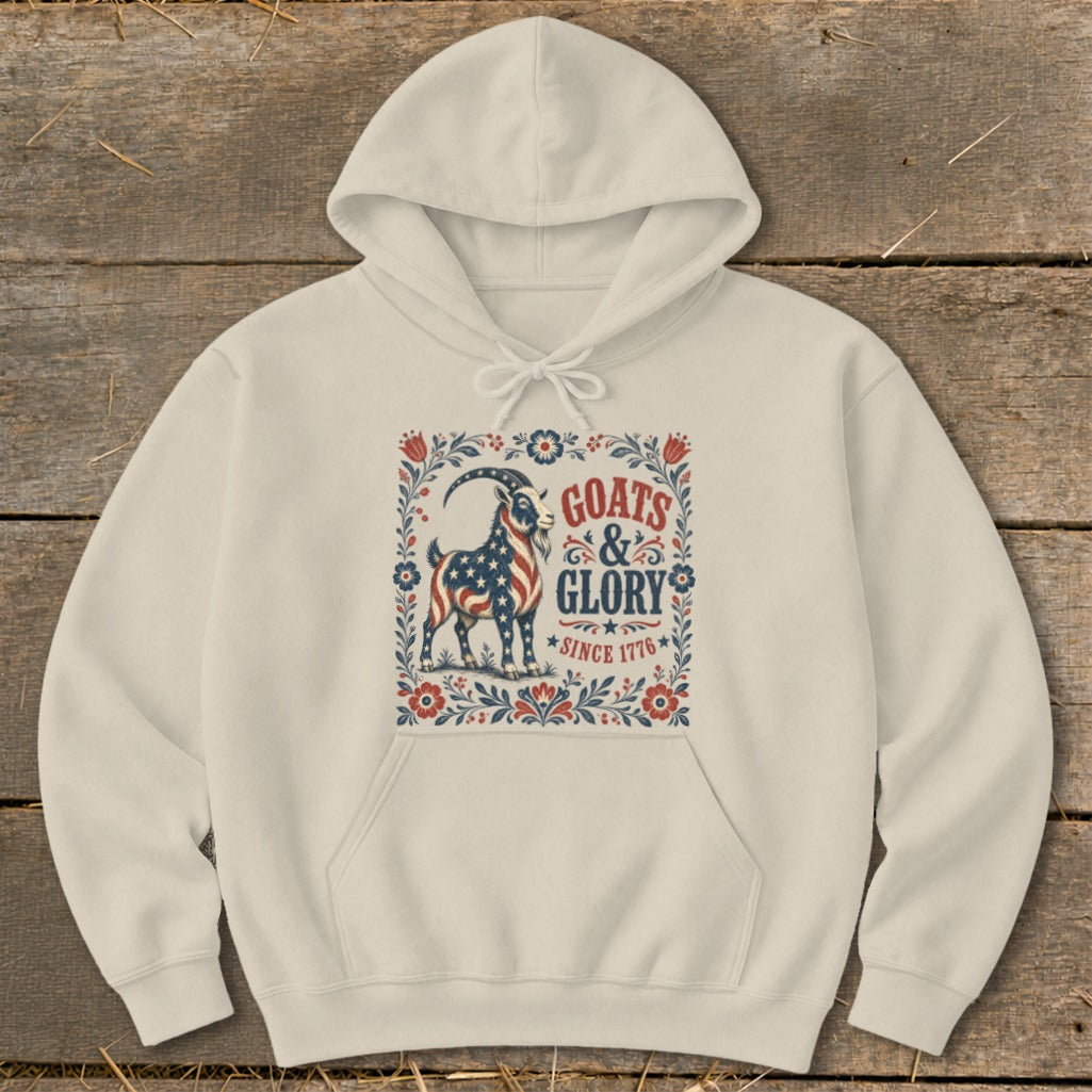 Cream hoodie with a goat design featuring the US flag and text "Goats & Glory Since 1776".