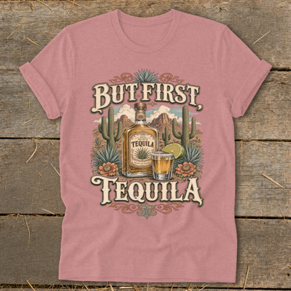 Pink t-shirt with "But First, Tequila" graphic featuring a tequila bottle, shot glass, and desert scene.