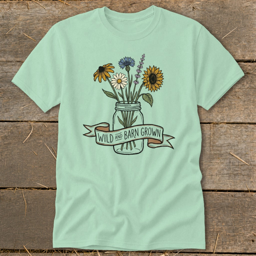 Light green t-shirt with a jar of wildflowers and "WILD AND BARN GROWN" banner.