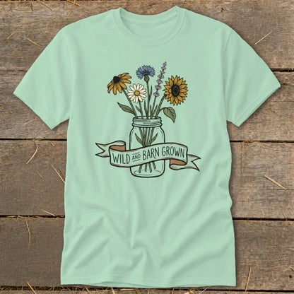 Light green t-shirt with a jar of wildflowers and "WILD AND BARN GROWN" banner.