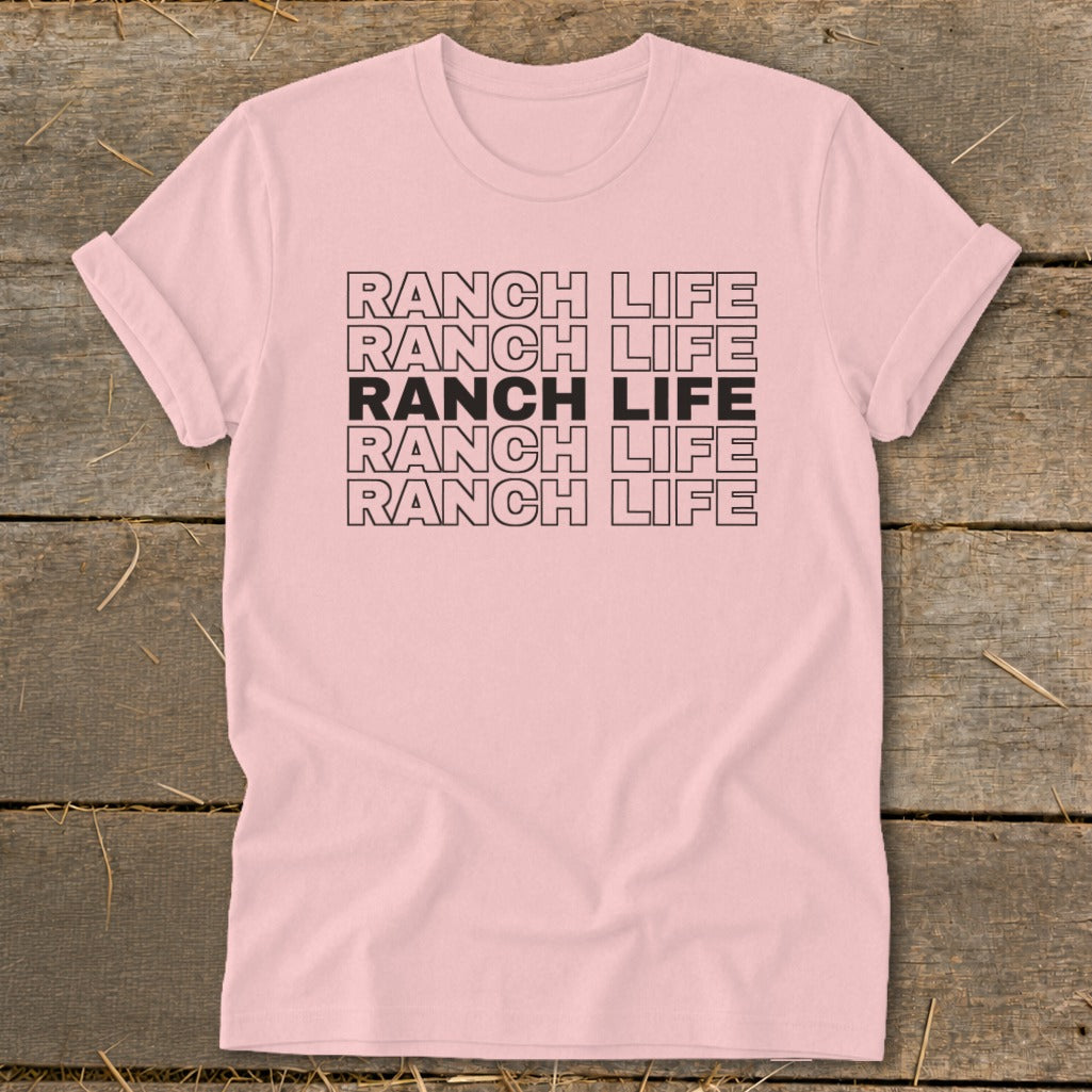 A light pink t-shirt with rolled sleeves features the text RANCH LIFE repeated in five stacked rows.