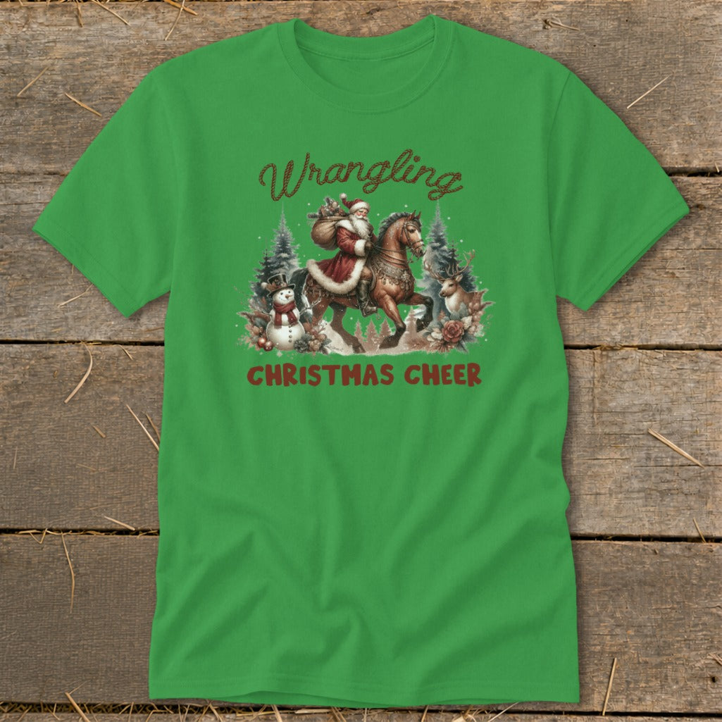 Green t-shirt with "Wrangling Christmas Cheer" text and Santa riding a horse with snowman and reindeer.