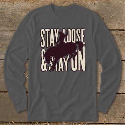 Dark grey long sleeve shirt with "STAY LOOSE & STAY ON" text and bucking horse graphic.