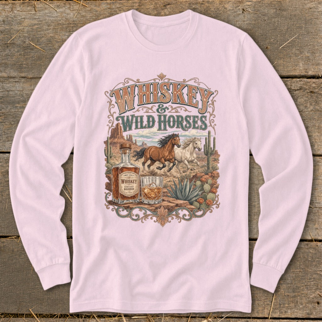 Whiskey & Wild Horses graphic on a light pink long-sleeve shirt featuring horses, whiskey bottle and glass.
