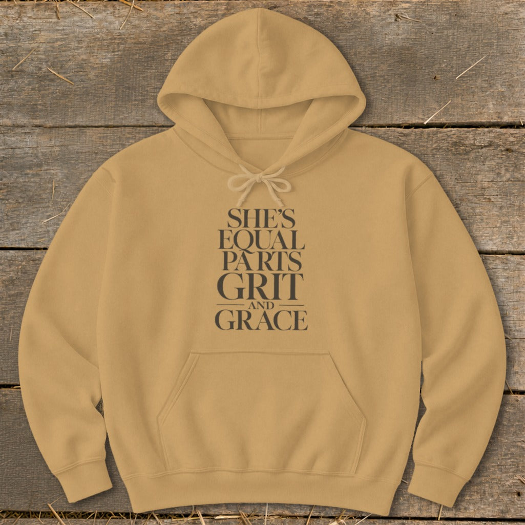 Tan hoodie with text "SHE'S EQUAL PARTS GRIT AND GRACE".