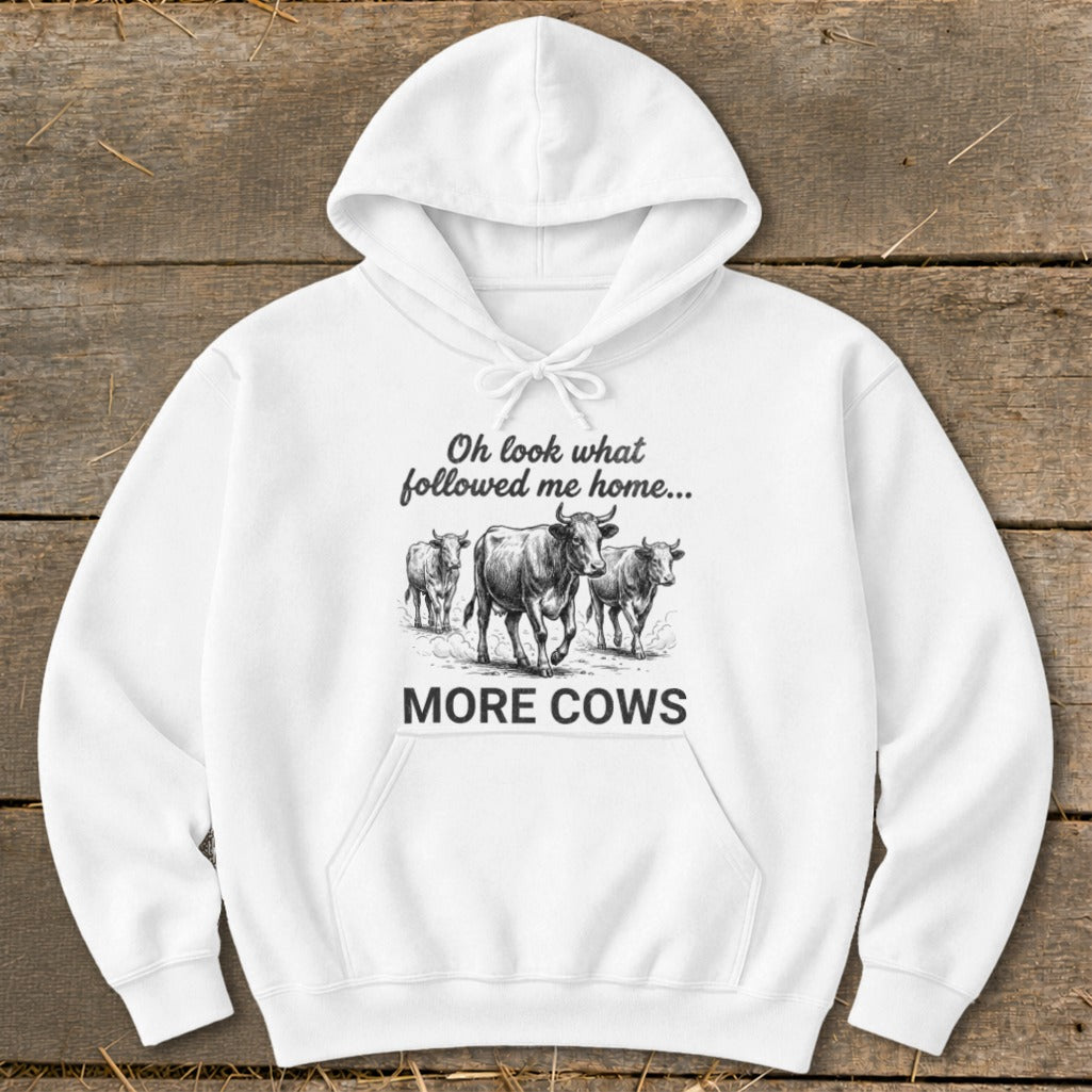 White hoodie with cows and text "Oh look what followed me home... MORE COWS".