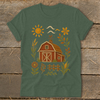 Green t-shirt with a red barn, sun, flowers, wheat, and corn illustration.