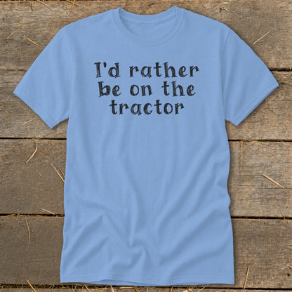 Light blue t-shirt with black text "I'd rather be on the tractor".