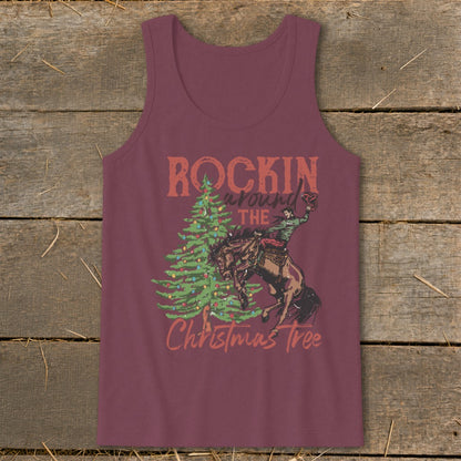 Maroon tank top with graphic of a bucking bronco rider and Christmas tree with text "Rockin around the Christmas tree".