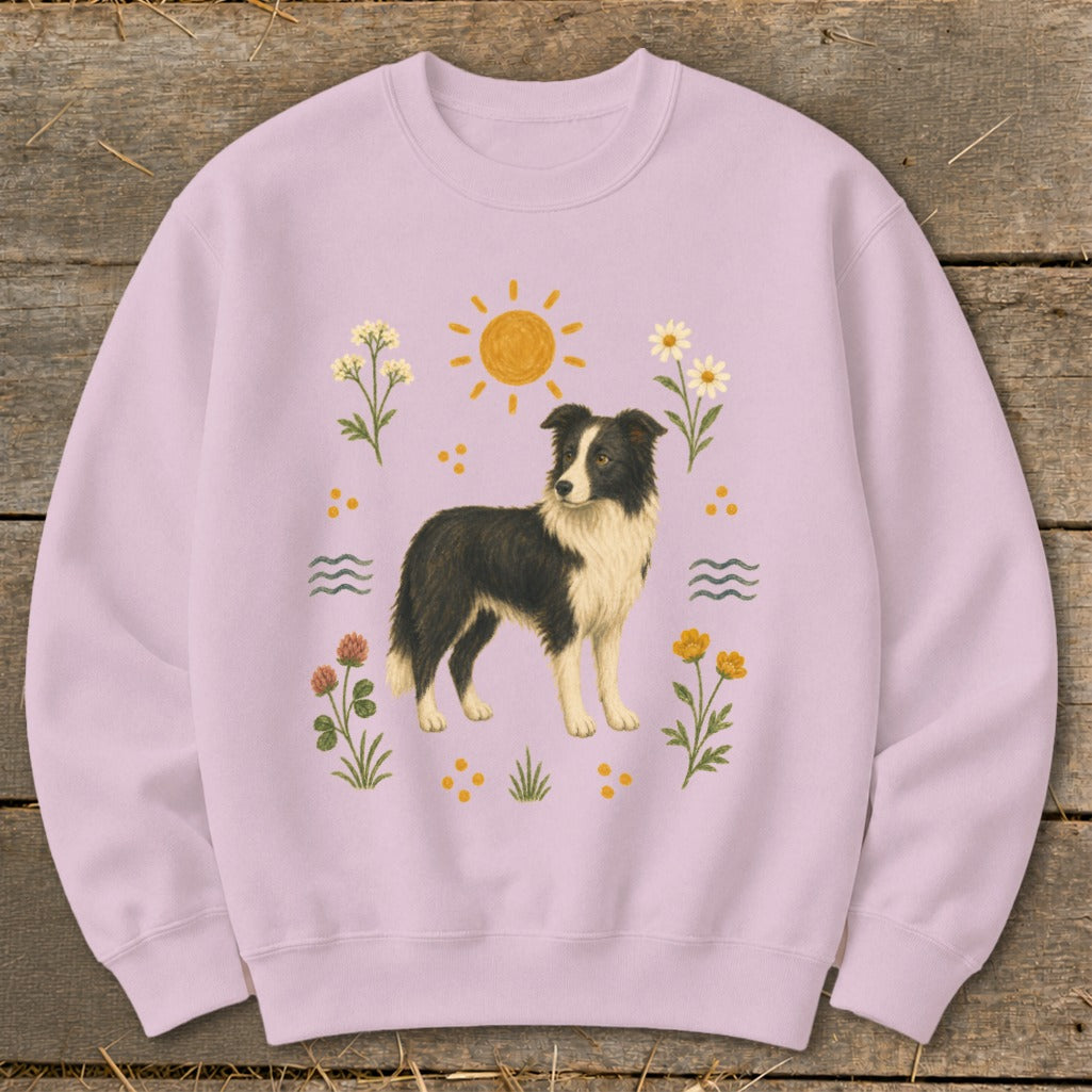 Lilac sweatshirt with a black and white border collie and floral graphics.