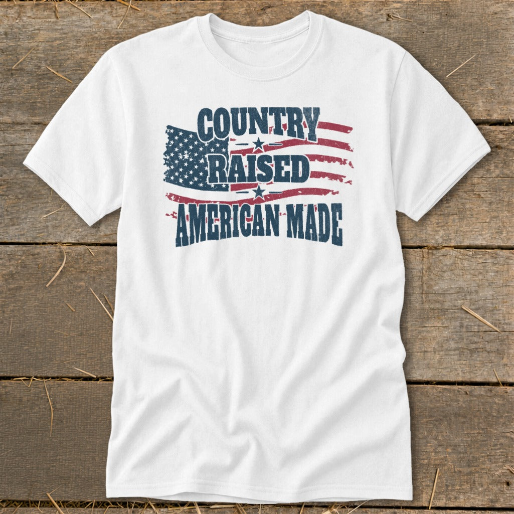 White t-shirt with "COUNTRY RAISED AMERICAN MADE" text and distressed US flag graphic.