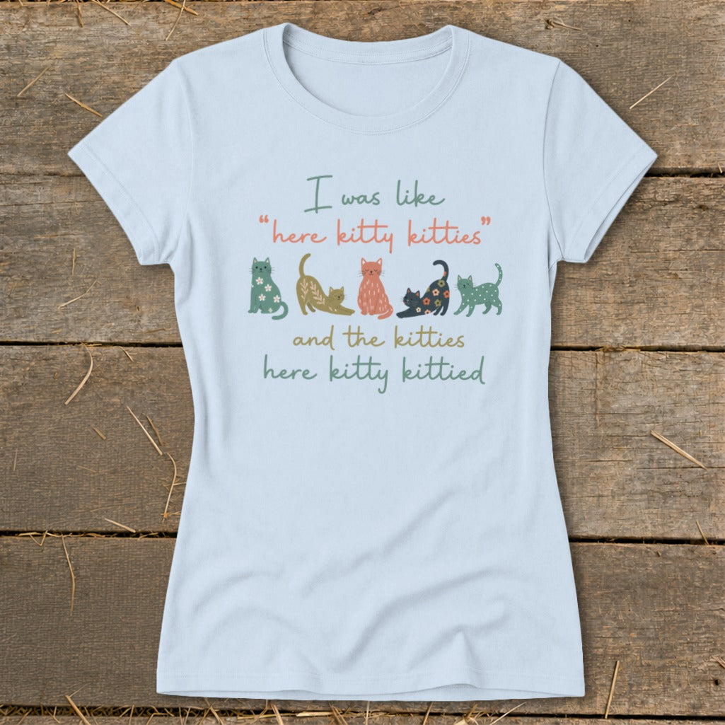 Light blue t-shirt with whimsical cats and text about kitties.