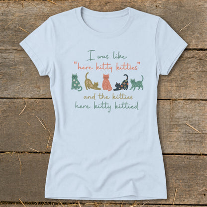 Light blue t-shirt with whimsical cats and text about kitties.