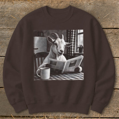 Brown crewneck sweatshirt featuring a graphic of a goat sitting at a checkered table reading a newspaper next to a mug.