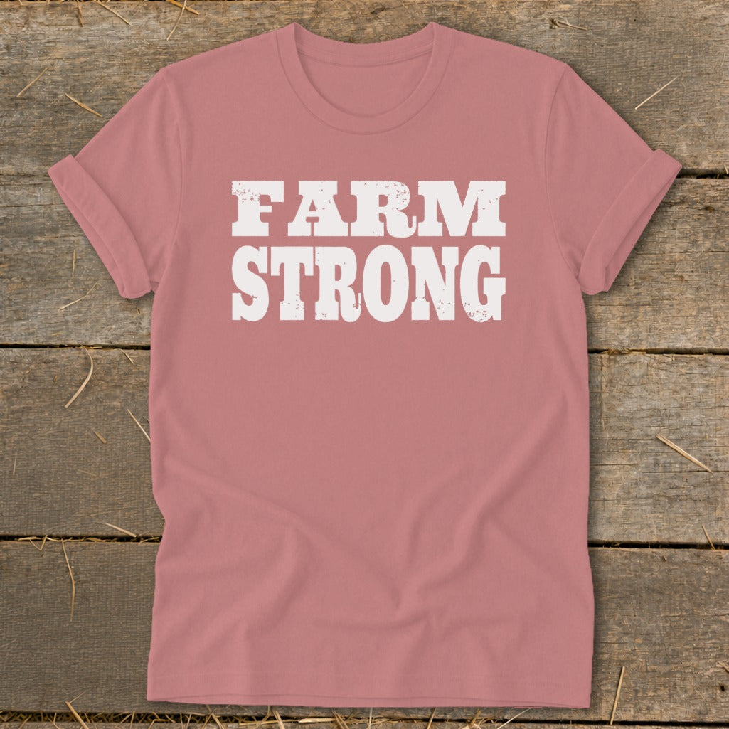 Dusty pink t-shirt with rolled sleeves featuring the white distressed text FARM STRONG.