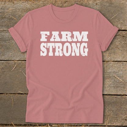 Dusty pink t-shirt with rolled sleeves featuring the white distressed text FARM STRONG.