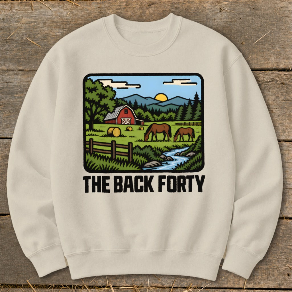 Cream-colored crewneck sweatshirt featuring a graphic of a farm scene with horses, a red barn, and the text The Back Forty.