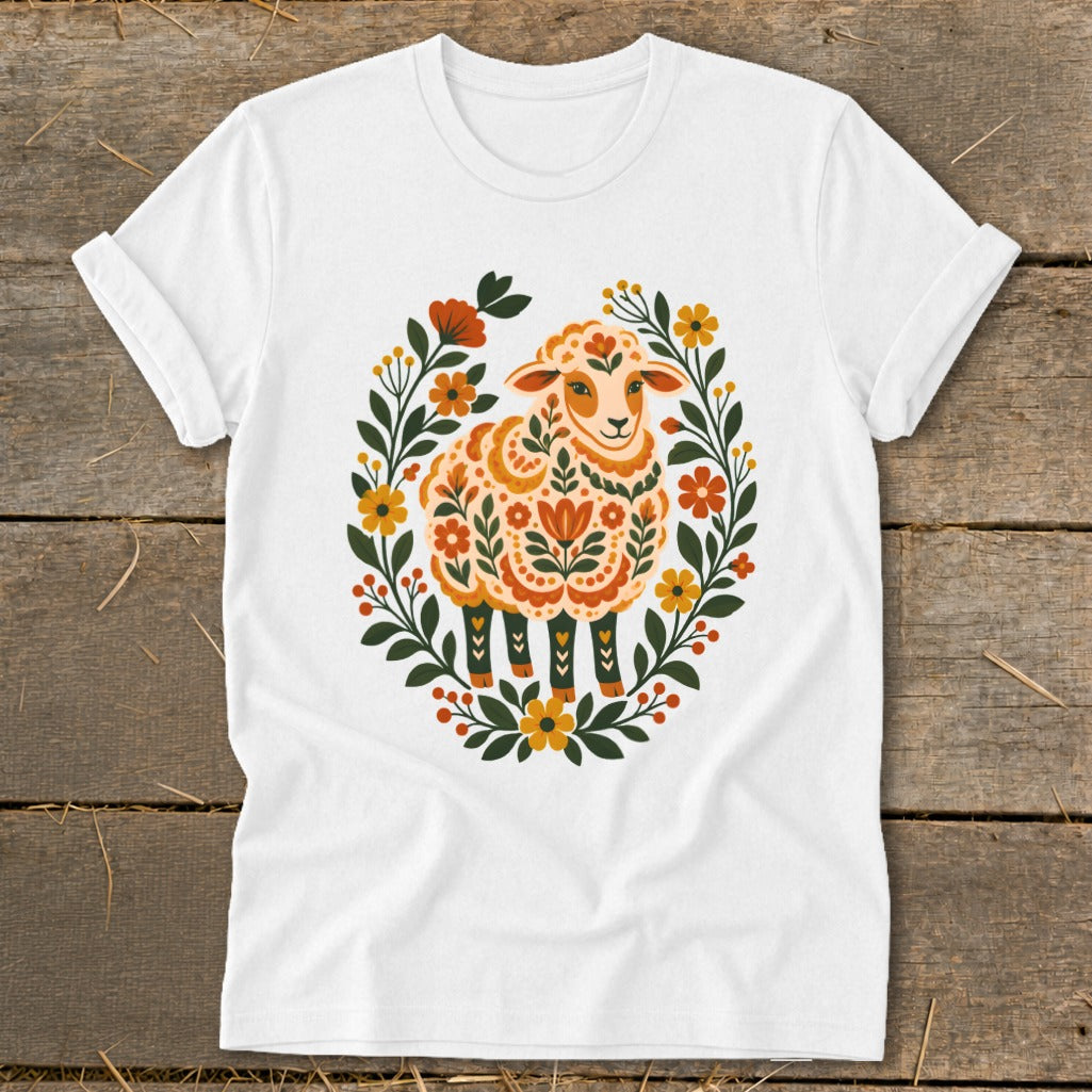 White t-shirt with a floral sheep design in orange and yellow.