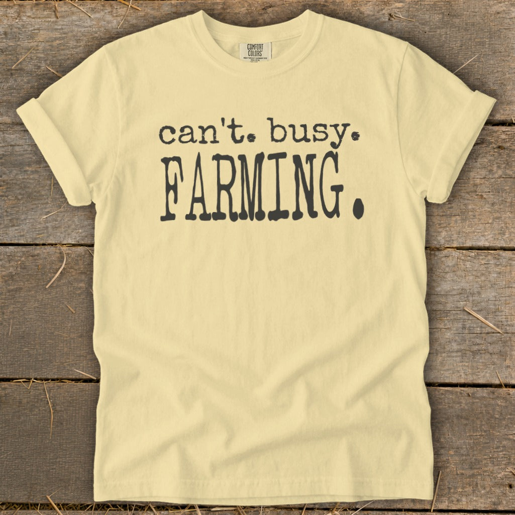 Light yellow t-shirt with black text reading "can't. busy. FARMING."