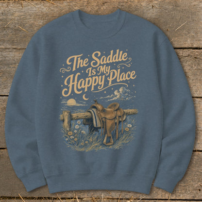 Sweatshirt with "The Saddle Is My Happy Place" text and a saddle on a fence.