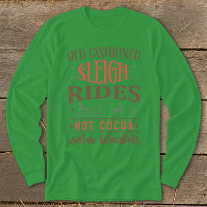 Green long-sleeve shirt with "Old Fashioned Sleigh Rides Hot Cocoa Warm Blankets" text.