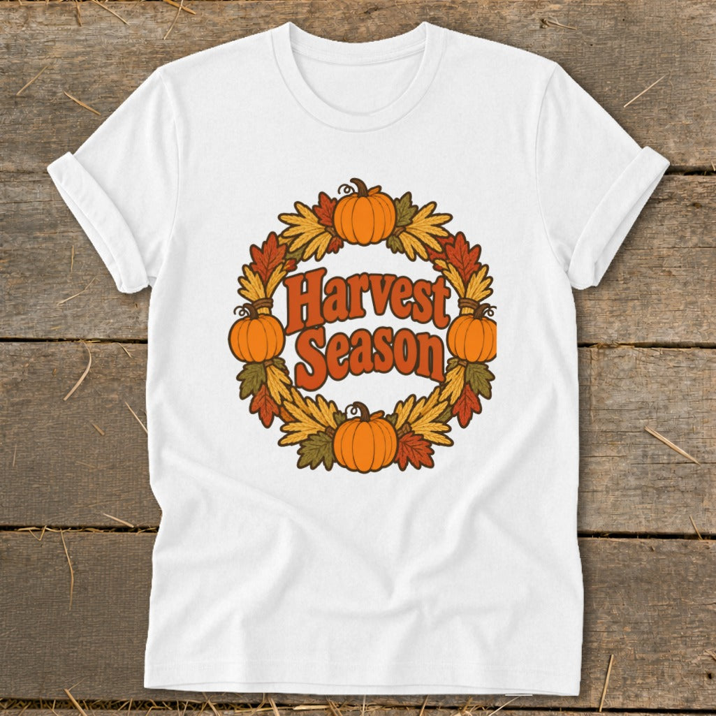 White t-shirt with "Harvest Season" text and pumpkin wreath graphic.