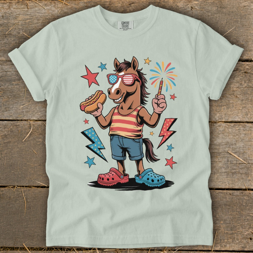 Horse wearing sunglasses, holding a hot dog and a sparkler, with fireworks.