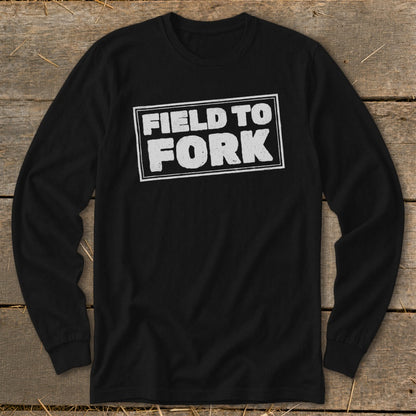 A black long-sleeve t-shirt with a white rectangular border enclosing the text "FIELD TO FORK" on the chest.