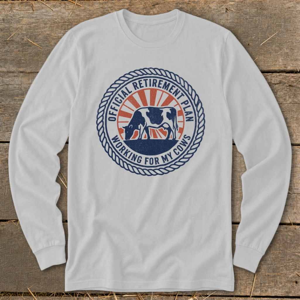 White long-sleeve shirt with a circular graphic reading "Official Retirement Plan Working For My Cows".
