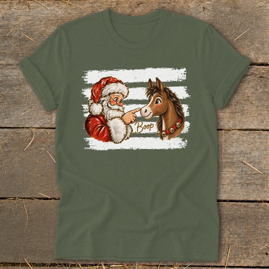 Santa Claus touching a horse's nose with the word "Boop" and bells on its neck.