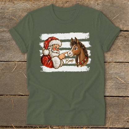 Santa Claus touching a horse's nose with the word "Boop" and bells on its neck.