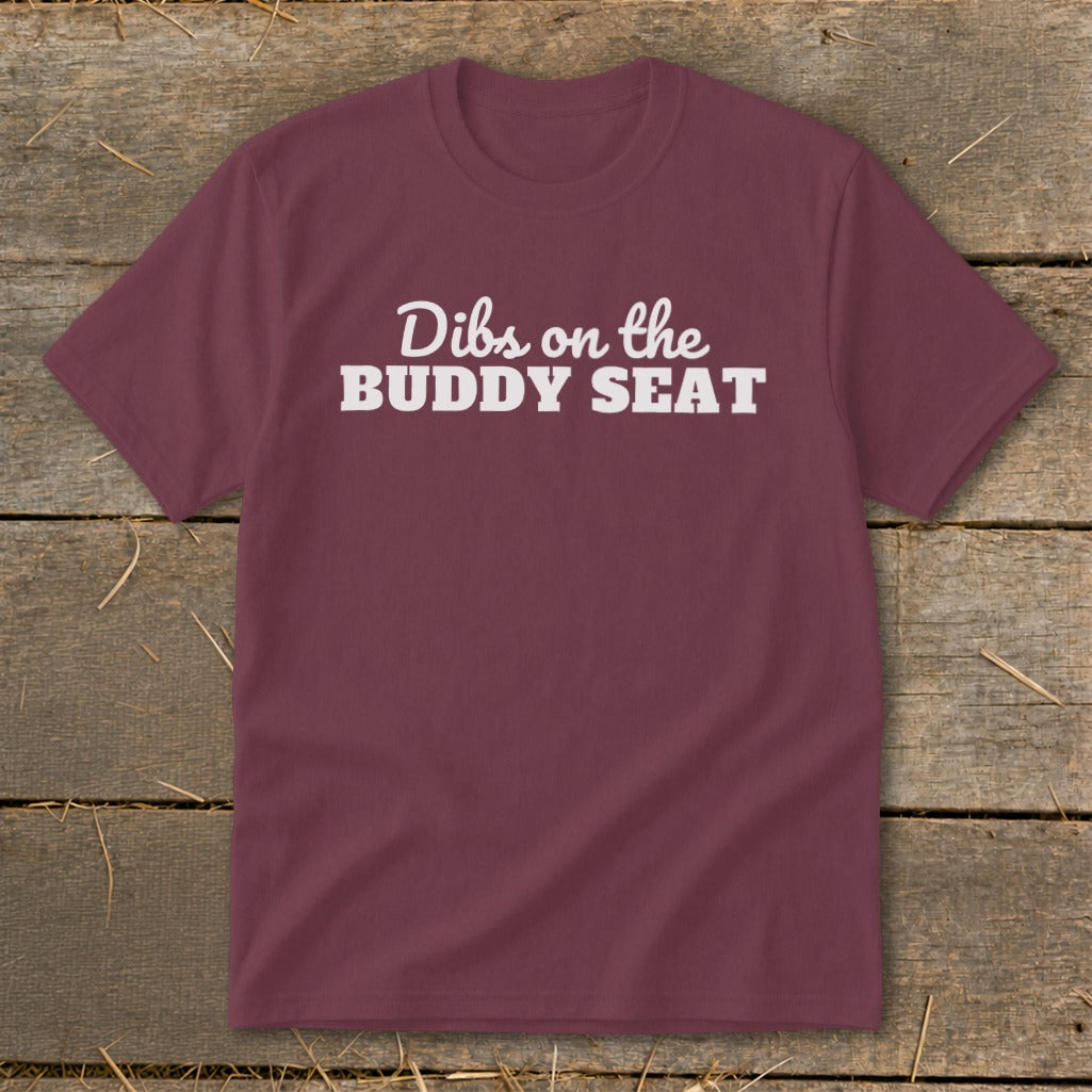 Maroon t-shirt with white text that reads "Dibs on the BUDDY SEAT".