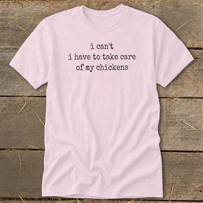 Pink t-shirt with "I can't i have to take care of my chickens" text.