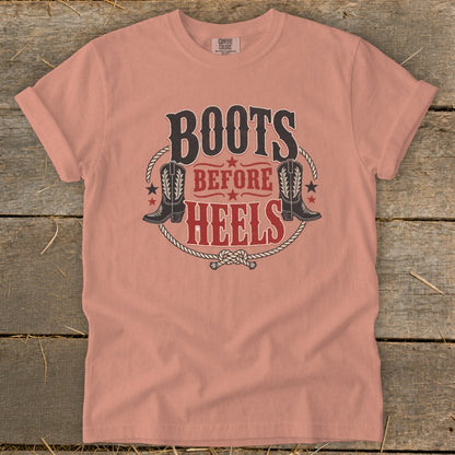 Peach t-shirt with "Boots Before Heels" graphic and cowboy boots.