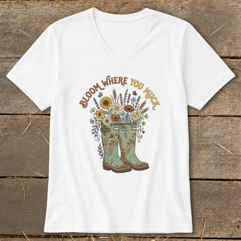 White t-shirt with green boots and flowers, says "Bloom Where You Muck."