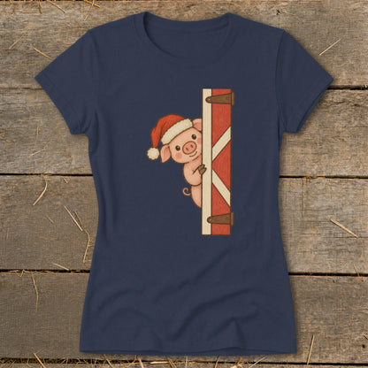 Pig in Santa hat peeking from behind barn door graphic on navy t-shirt.