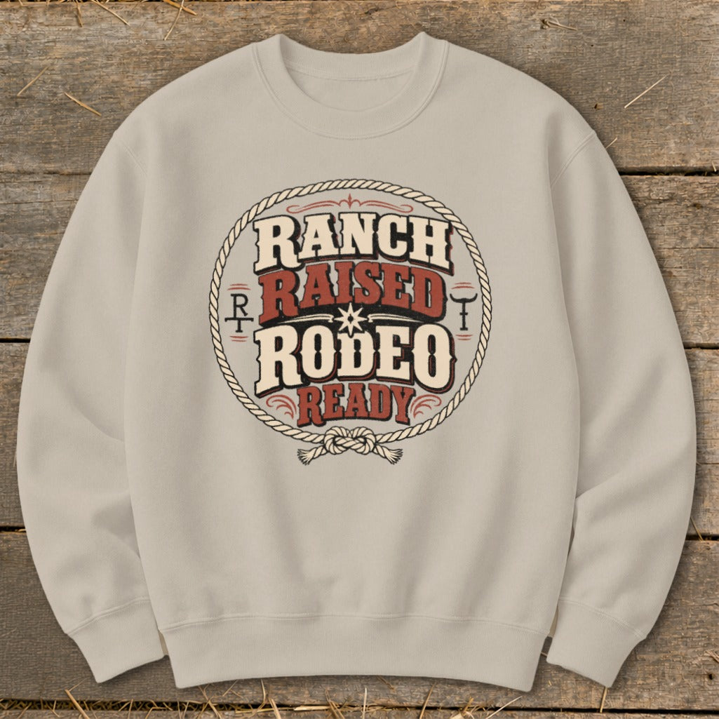 Light tan crewneck sweatshirt with "Ranch Raised Rodeo Ready" text in a circle.