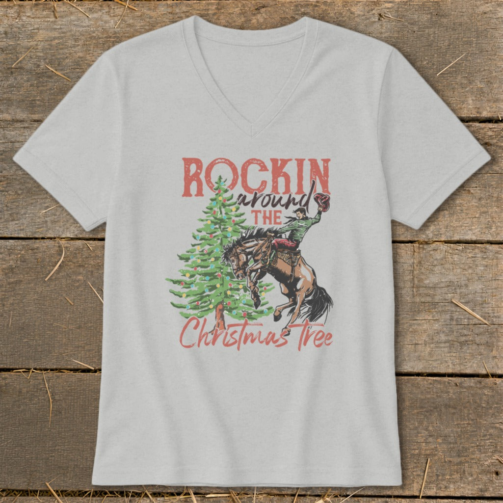 T-shirt graphic with "Rockin around the Christmas Tree" text and cowboy on bucking horse.