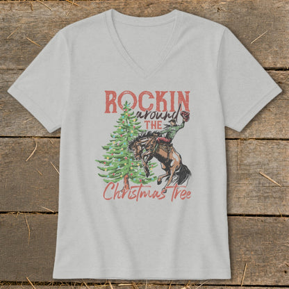 T-shirt graphic with "Rockin around the Christmas Tree" text and cowboy on bucking horse.