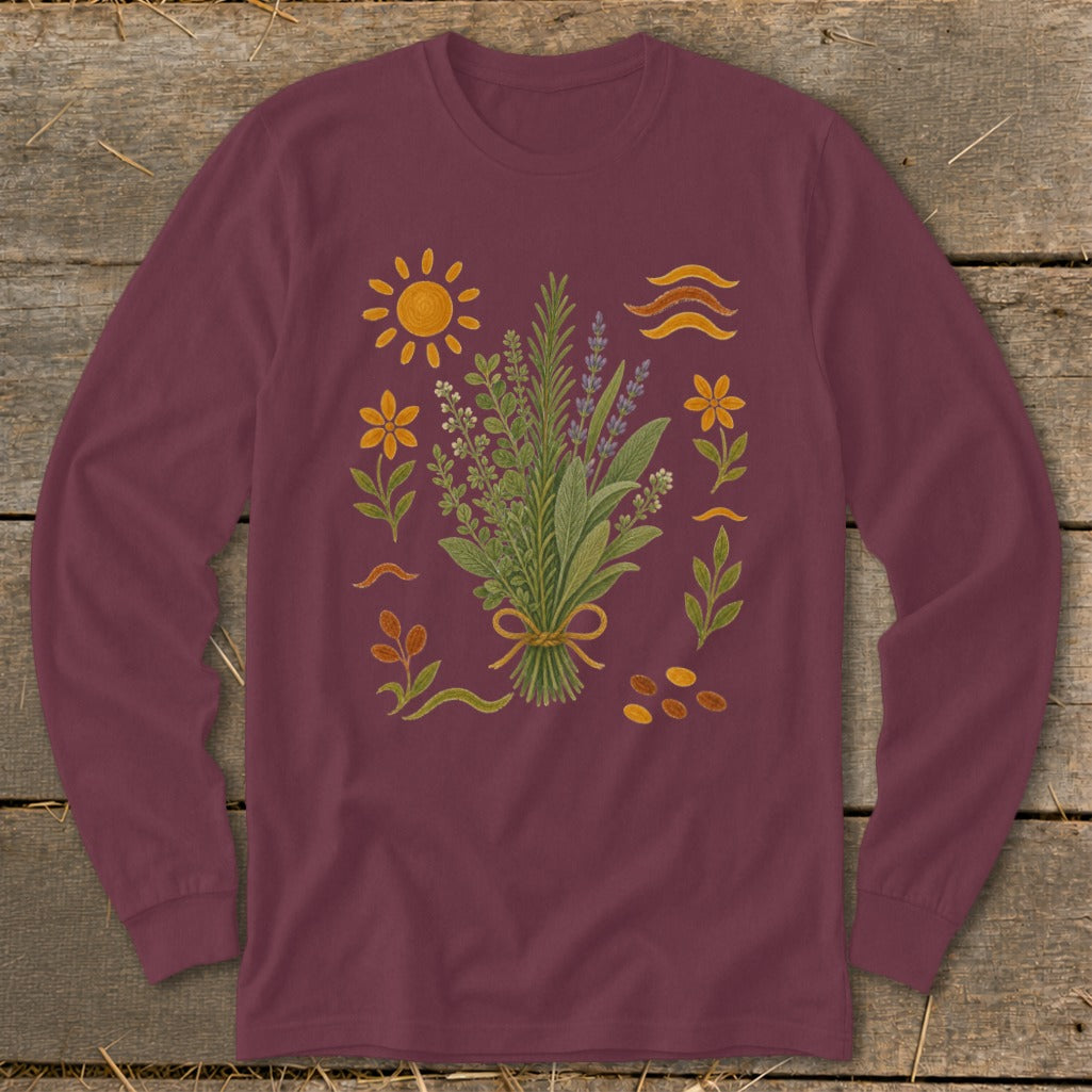 Maroon long-sleeve shirt with a central bouquet of herbs surrounded by botanical elements and a sun.