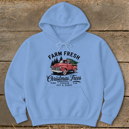 Light blue hoodie with "Farm Fresh Christmas Trees" design featuring a red truck.