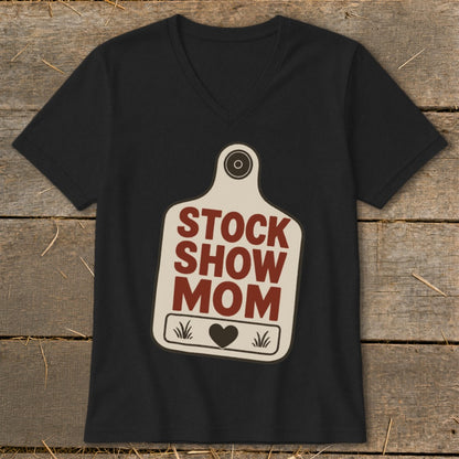 Black v-neck t-shirt with "STOCK SHOW MOM" text on a cow tag graphic.