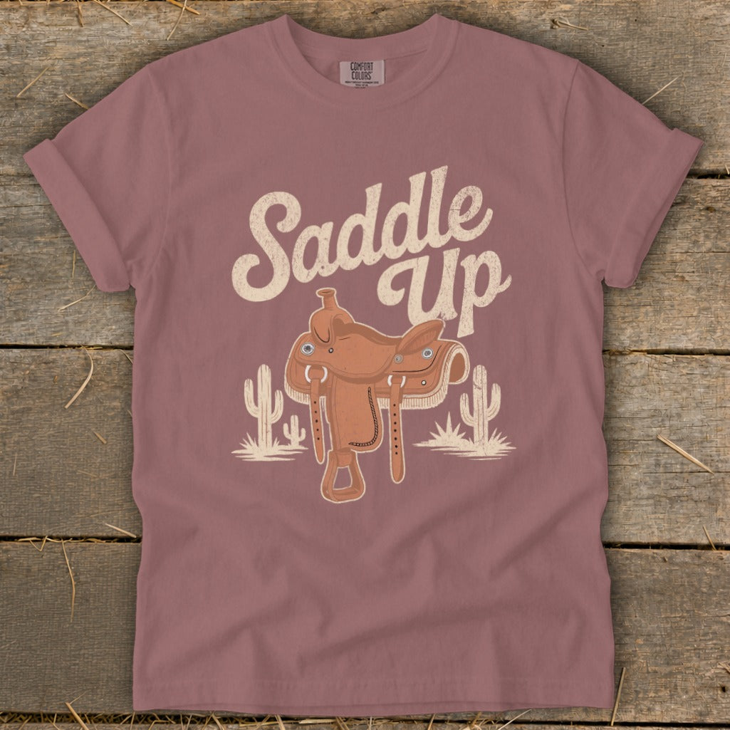 T-shirt with "Saddle Up" text, a cowboy saddle, and cacti illustration.